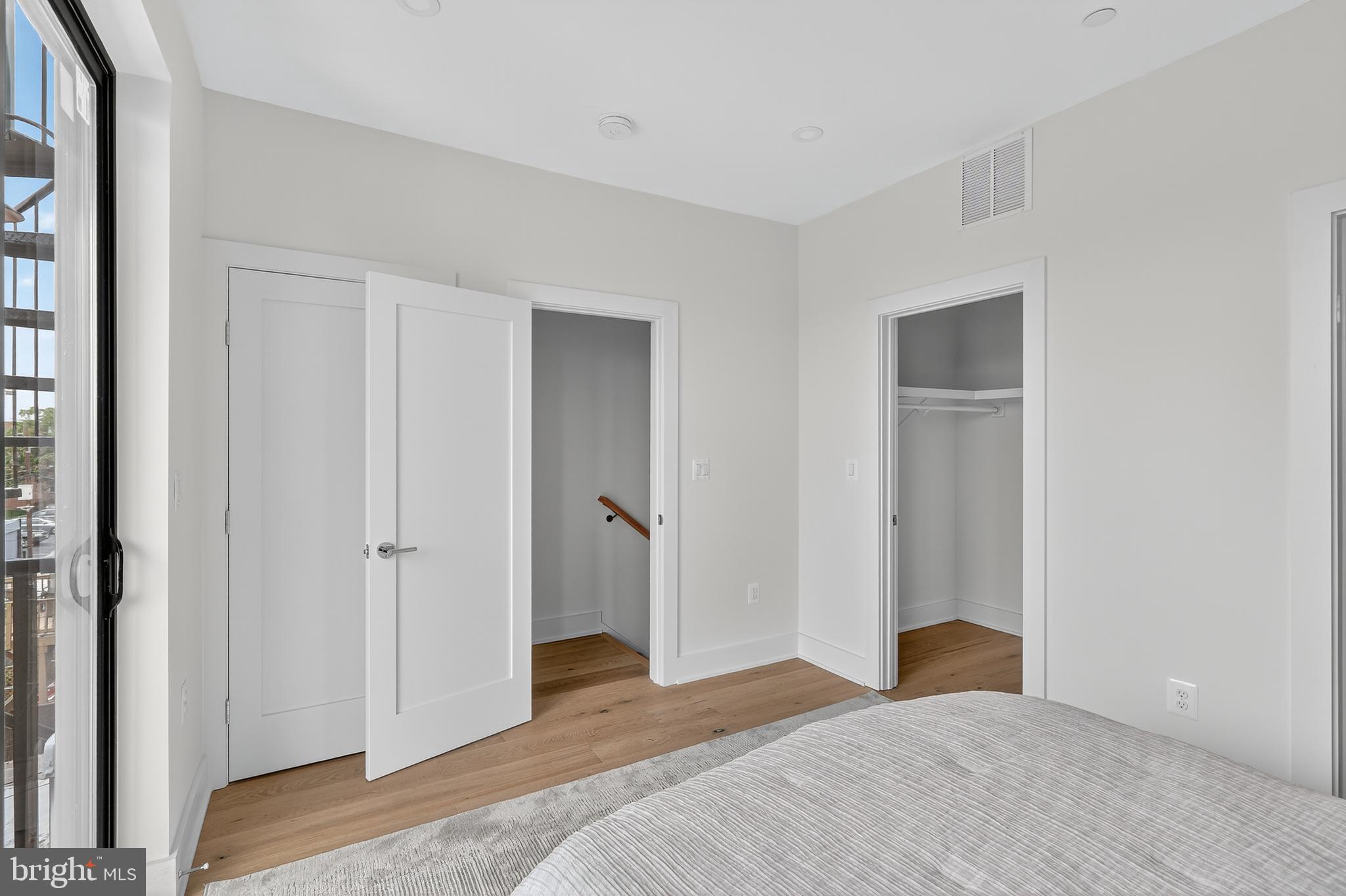 828 21st Street Northeast, Unit 2 Washington, DC 20002 - Photo 23 of 27 a bedroom with a bed and a mirror