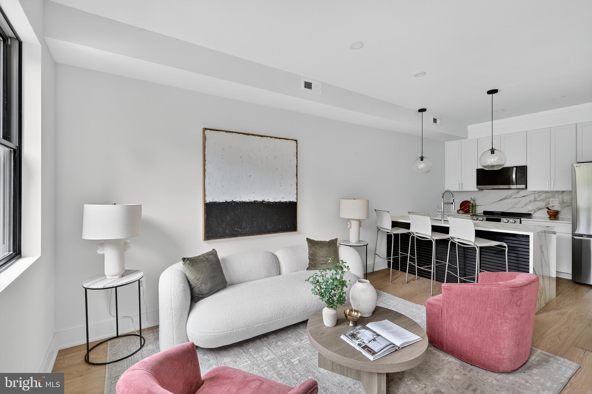 828 21st Street Northeast, Unit 2 Washington, DC 20002 - Photo 8 of 27 a living room with furniture a rug kitchen view and a window