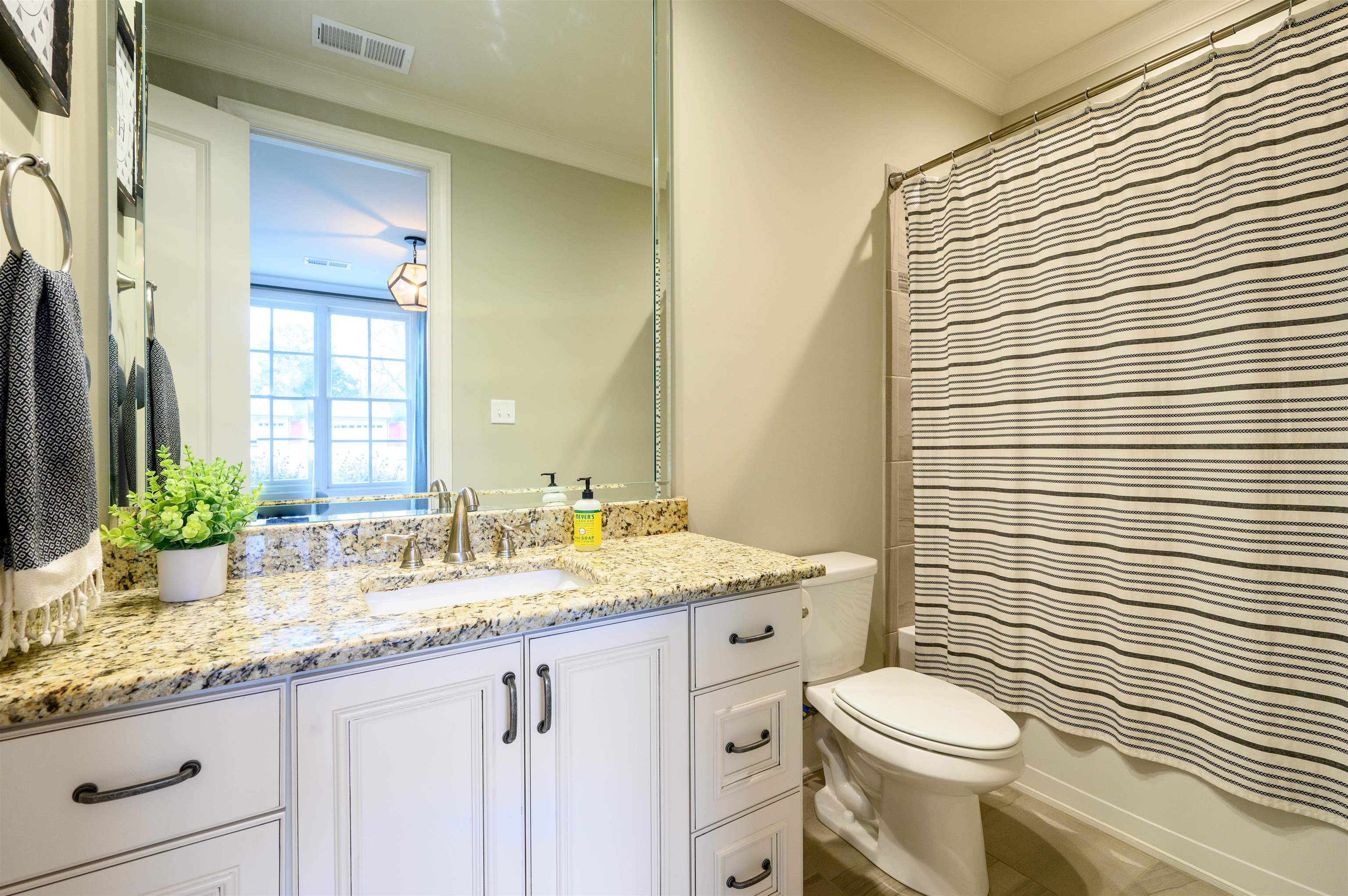 4980 Cole Road Memphis, TN 38117 - Photo 11 of 25 a bathroom with a granite countertop toilet a sink and a mirror