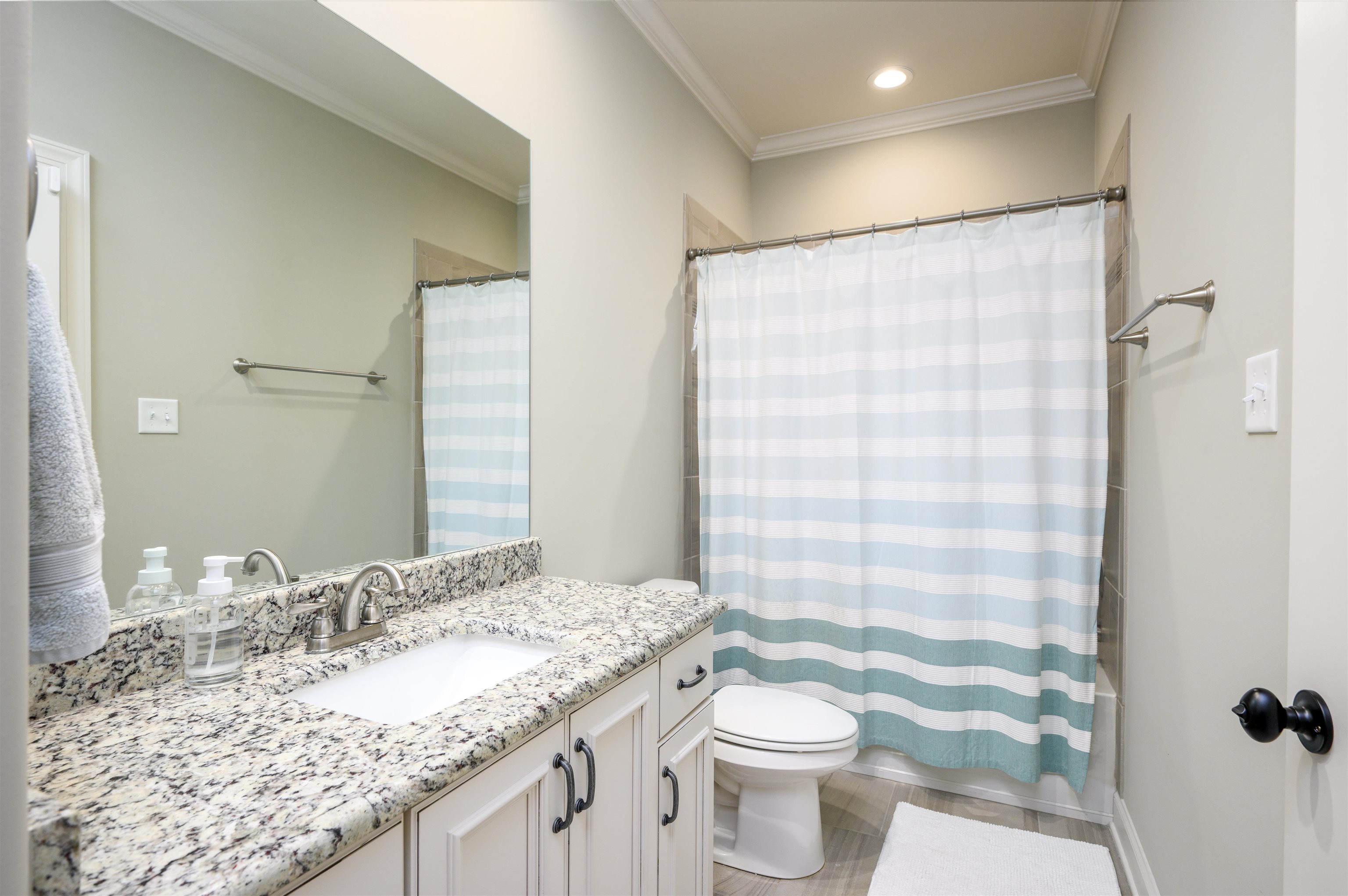 4980 Cole Road Memphis, TN 38117 - Photo 18 of 25 a bathroom with a granite countertop sink toilet and shower