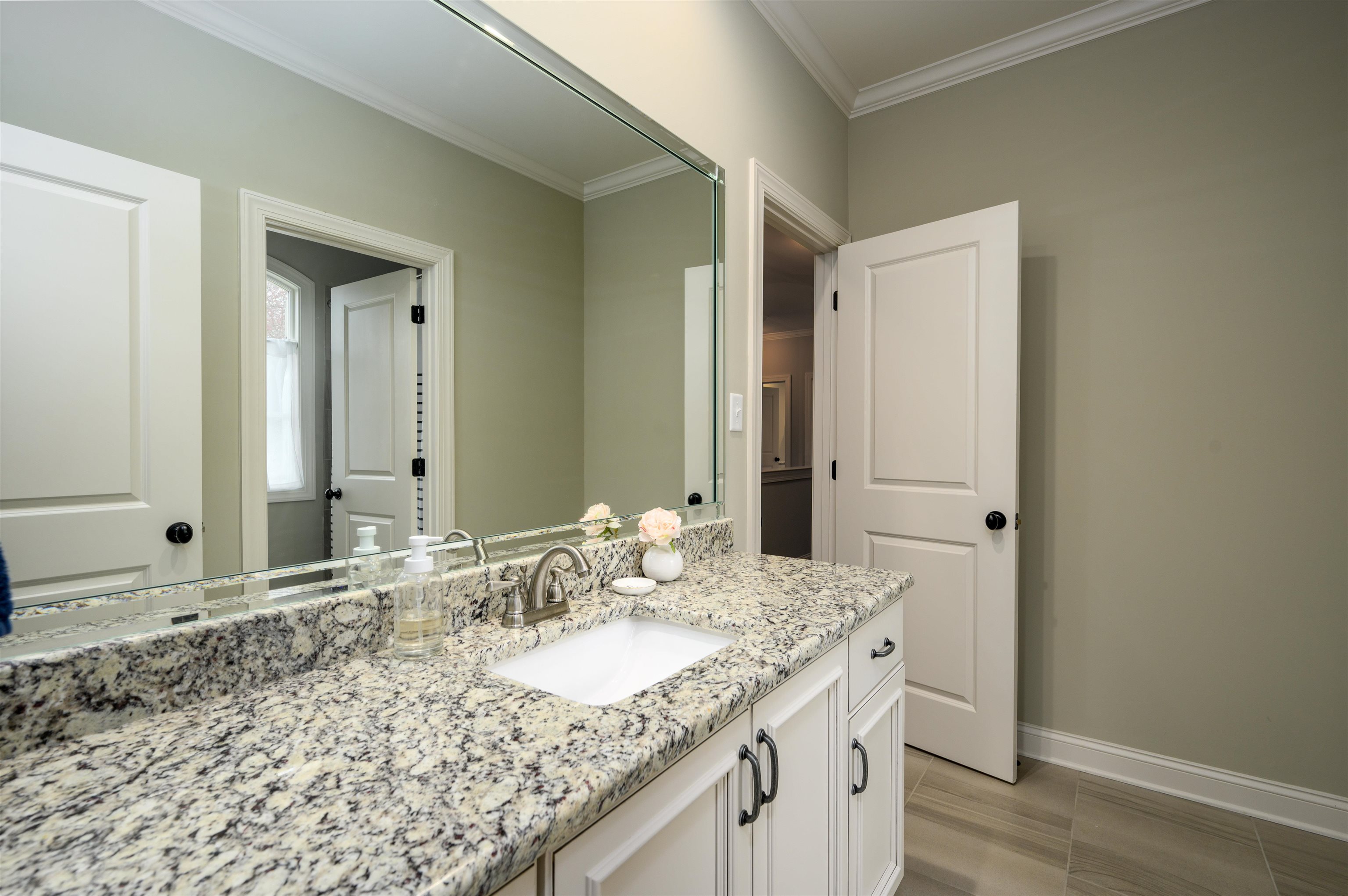 4980 Cole Road Memphis, TN 38117 - Photo 20 of 25 a bathroom with a granite countertop sink and a mirror