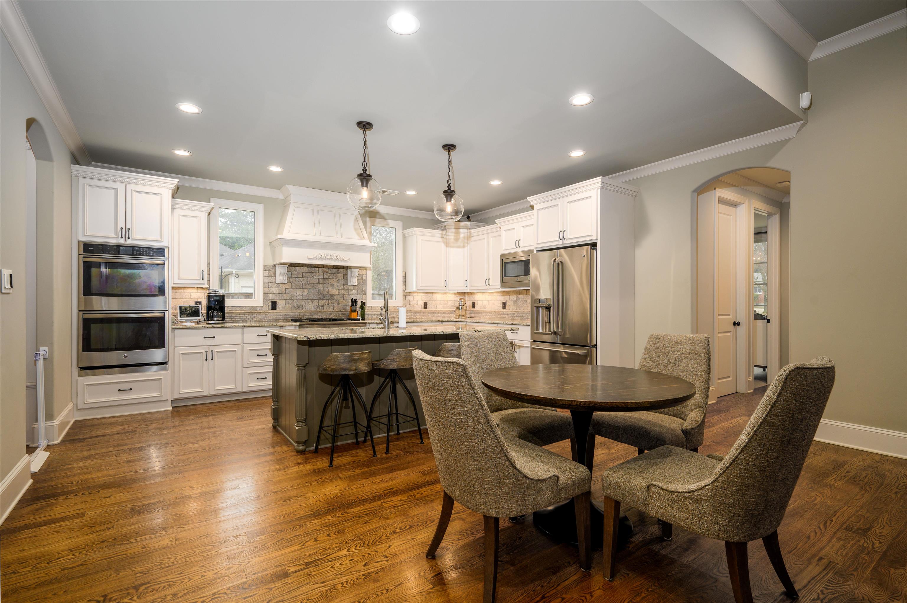 4980 Cole Road Memphis, TN 38117 - Photo 7 of 25 a kitchen with stainless steel appliances kitchen island granite countertop a table chairs and a refrigerator