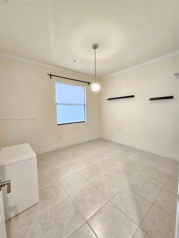 a view of a room with a ceiling fan and window