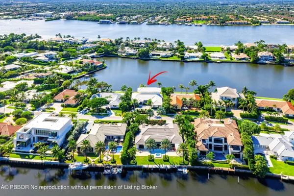 an aerial view of residential houses with outdoor space and boats