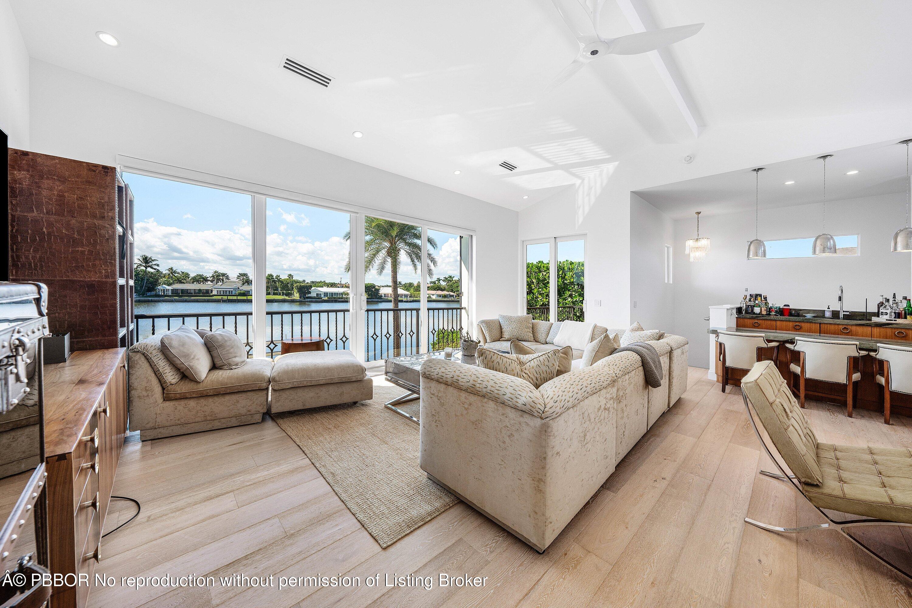 50 Spoonbill Road Lantana, FL 33462 - Photo 22 of 38 a living room with furniture wooden floor and a large window