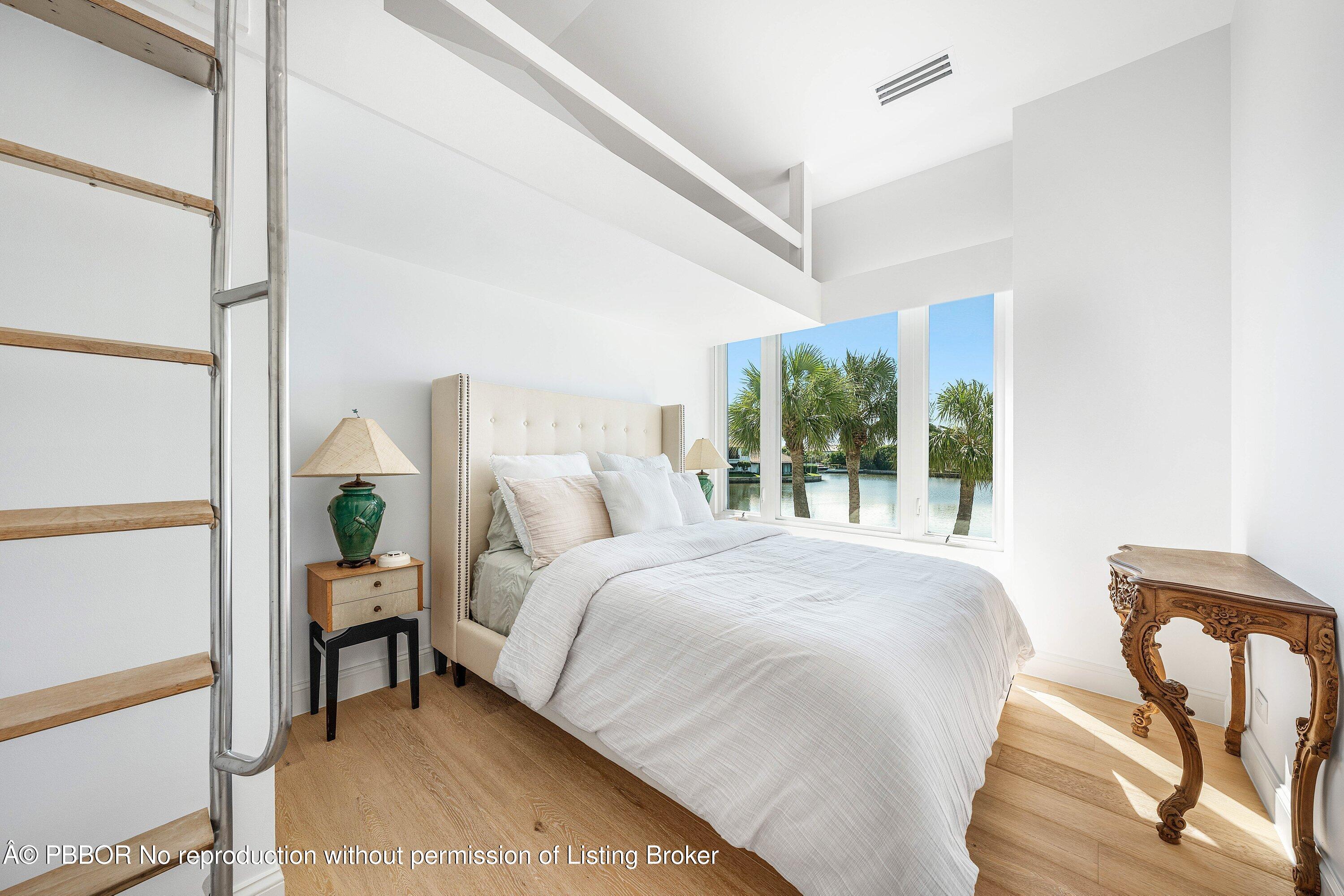 50 Spoonbill Road Lantana, FL 33462 - Photo 23 of 38 a bedroom with a bed and a large window