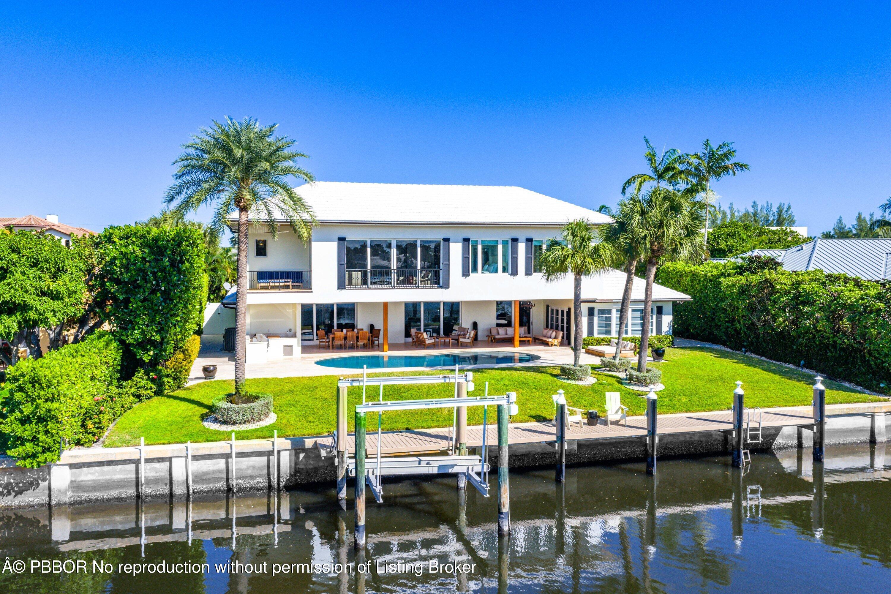 50 Spoonbill Road Lantana, FL 33462 - Photo 29 of 38 a view of a swimming pool with a chair and tables