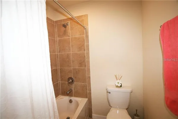 a bathroom with a toilet and shower