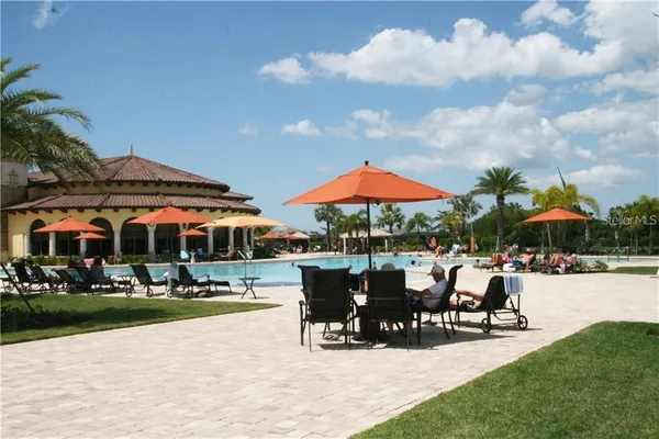 a view of patio with chairs and tables