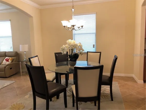 a dining room with furniture and window