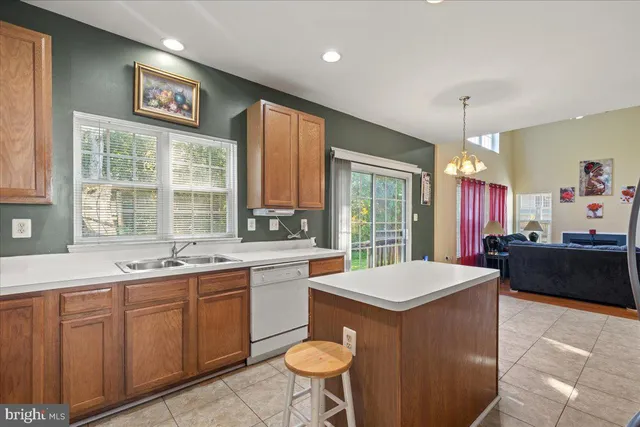 a large kitchen with kitchen island a large counter space windows and appliances