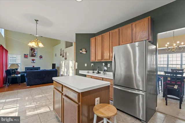 a kitchen with stainless steel appliances a refrigerator sink and wooden floor