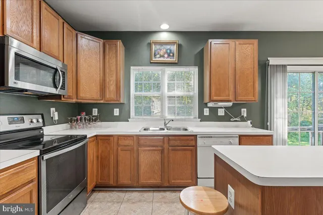 a kitchen with a sink stove top oven and microwave