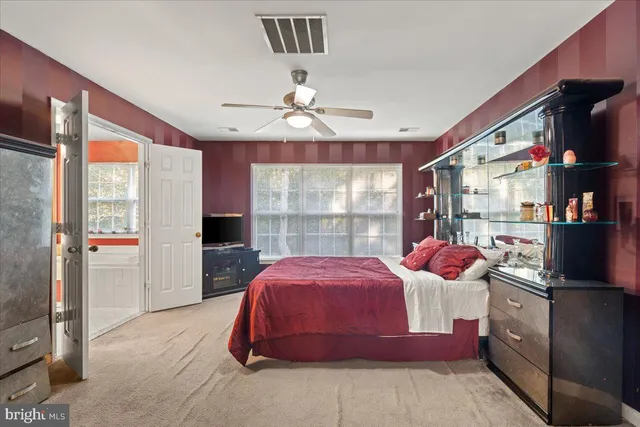 a bedroom with a bed and large window