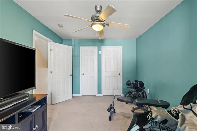 a room with gym equipment and flat screen tv