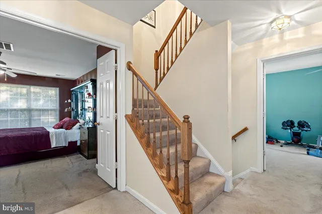 a view of entryway bedroom and hall with wooden floor
