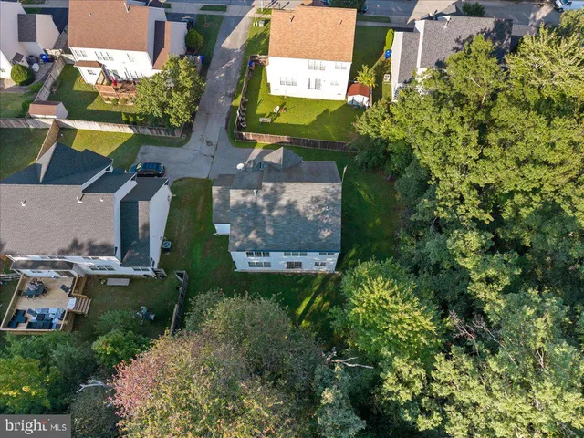 an aerial view of a houses with yard