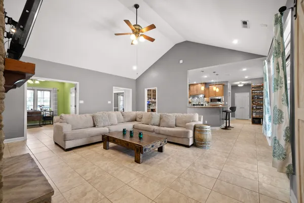 a kitchen with stainless steel appliances granite countertop a stove microwave and refrigerator