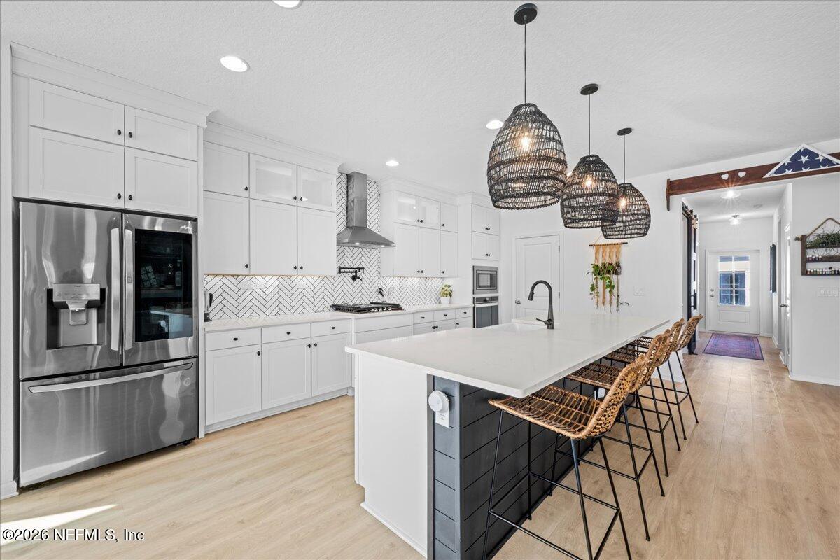 92 Patina Place St. Augustine, FL 32092 - Photo 4 of 26 a kitchen with stainless steel appliances a stove a sink a refrigerator and a center island