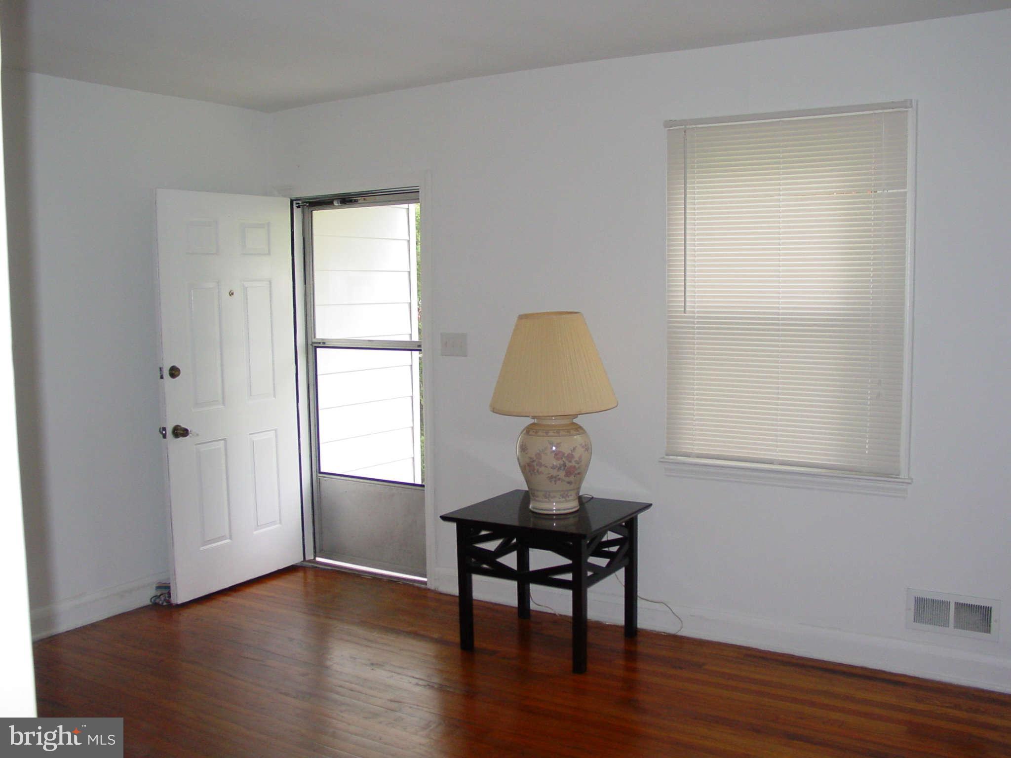 7903 Bon Air Road Baltimore, MD 21234 - Photo 3 of 17 a room with wooden floor and a window