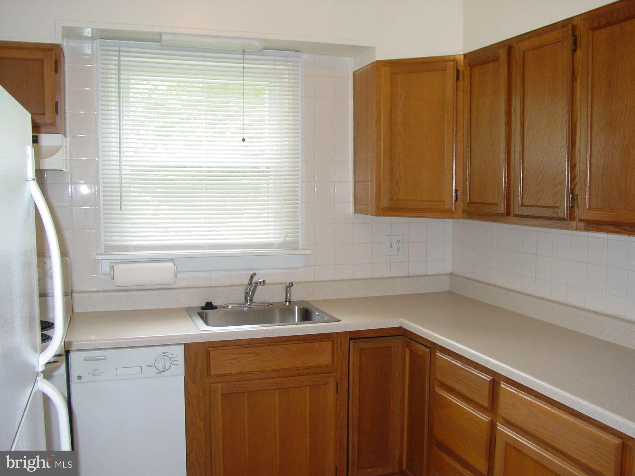 7903 Bon Air Road Baltimore, MD 21234 - Photo 5 of 17 a kitchen with a sink cabinets and window