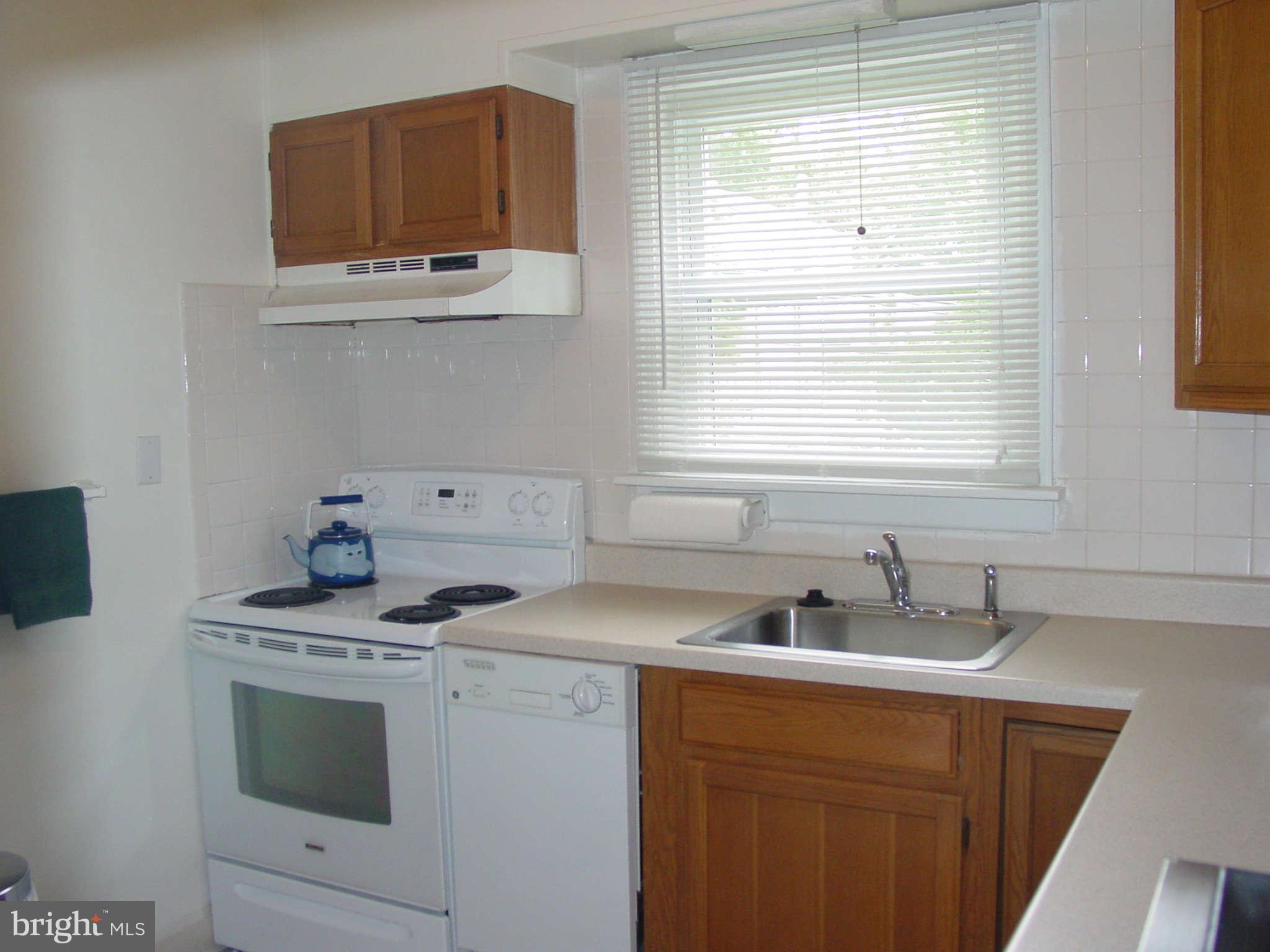 7903 Bon Air Road Baltimore, MD 21234 - Photo 6 of 17 a kitchen with stainless steel appliances a sink stove and microwave