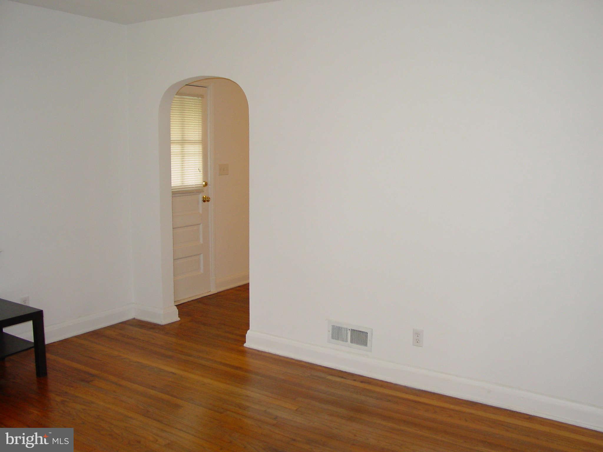 7903 Bon Air Road Baltimore, MD 21234 - Photo 7 of 17 a view of empty room with wooden floor and fan
