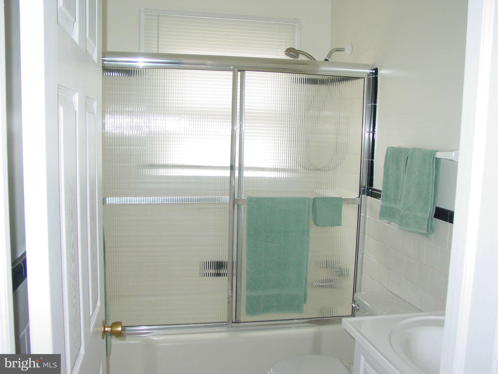 7903 Bon Air Road Baltimore, MD 21234 - Photo 10 of 17 a bathroom with a glass shower door