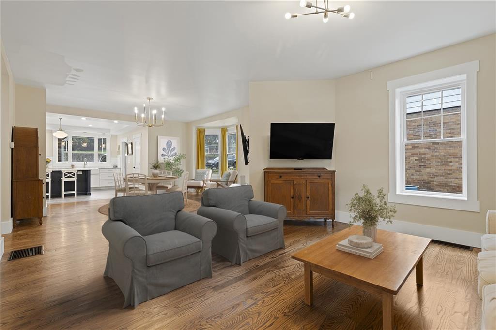 103 Main Street Ambridge, PA 15003 - Photo 11 of 49 a living room with furniture a dining table and a flat screen tv