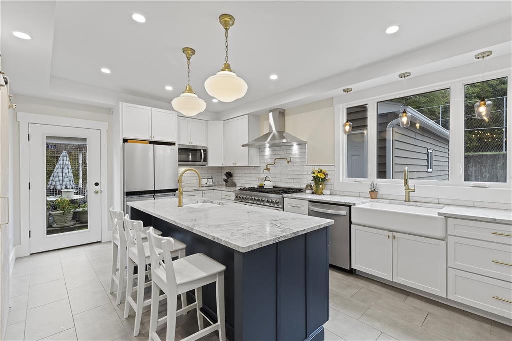 103 Main Street Ambridge, PA 15003 - Photo 13 of 49 a kitchen with center island and stainless steel appliances