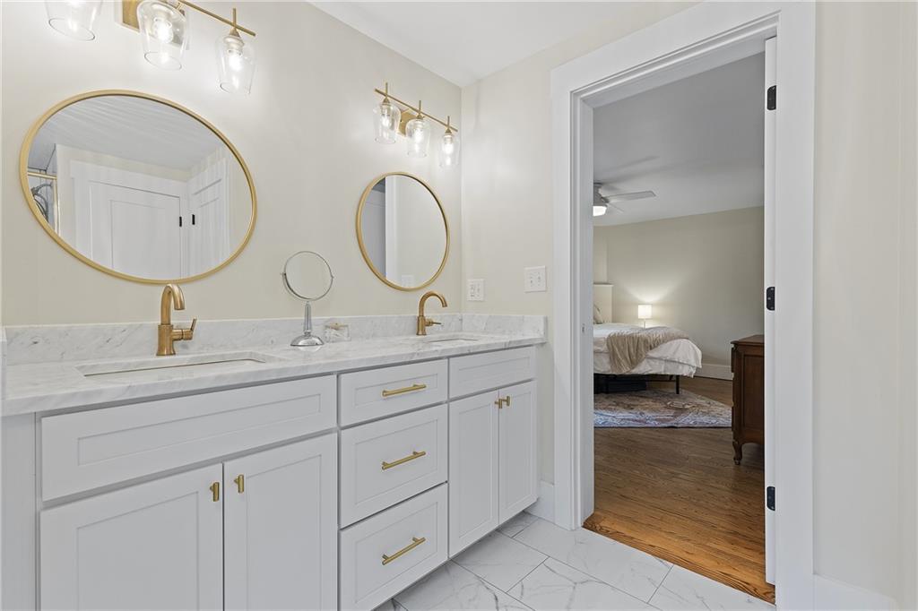 103 Main Street Ambridge, PA 15003 - Photo 24 of 49 a en suite bathroom with a granite countertop double vanity sink and a mirror