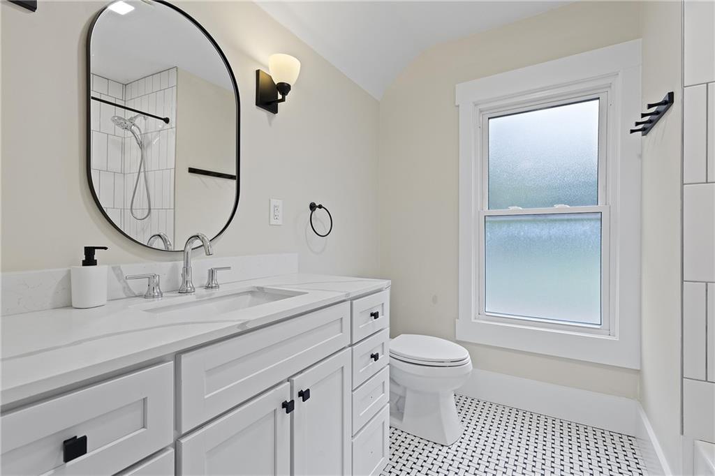 103 Main Street Ambridge, PA 15003 - Photo 28 of 49 a bathroom with a sink a toilet and a mirror