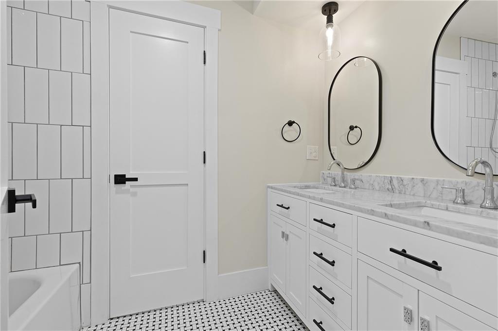 103 Main Street Ambridge, PA 15003 - Photo 31 of 49 a bathroom with a granite countertop sink a mirror and a shower