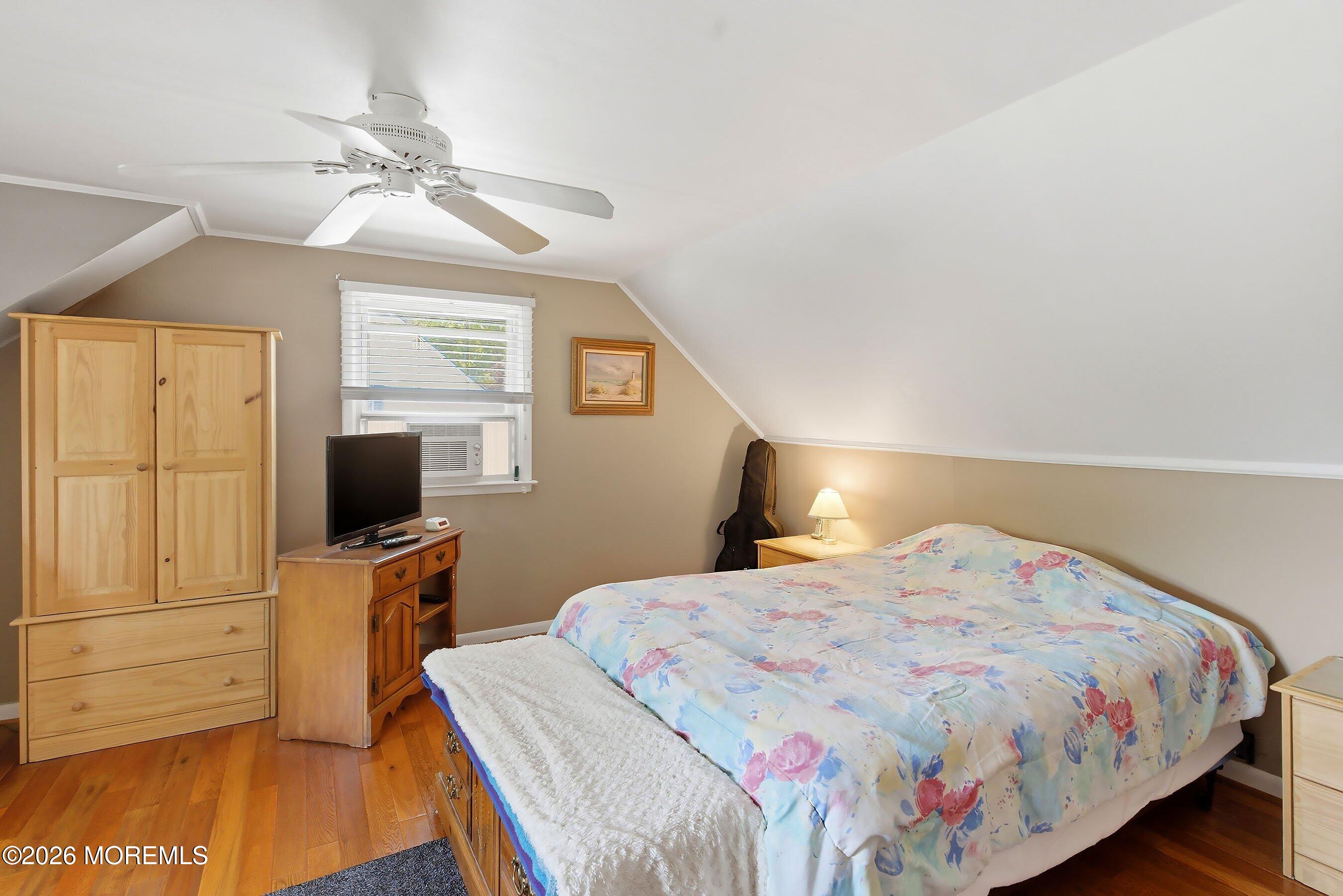 412 Moore Road Neptune Township, NJ 07753 - Photo 20 of 36 a bedroom with a bed and wooden floor