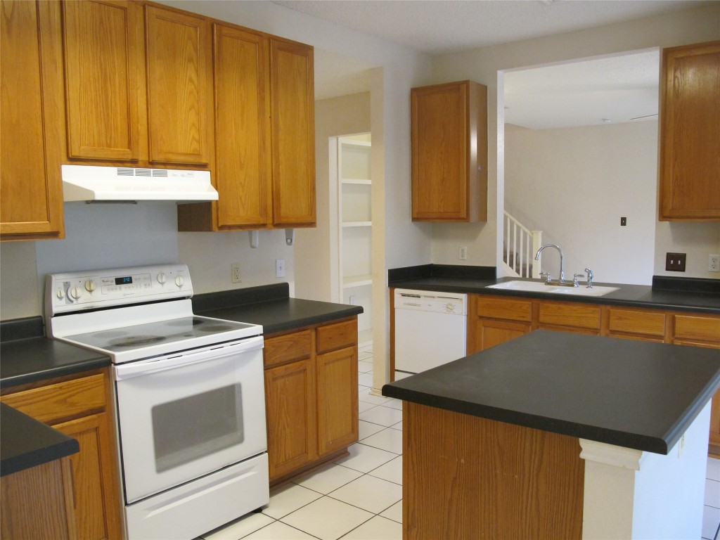 2011 Jasper Lane Cedar Park, TX 78613 - Photo 19 of 40 a kitchen with a sink and a stove top oven