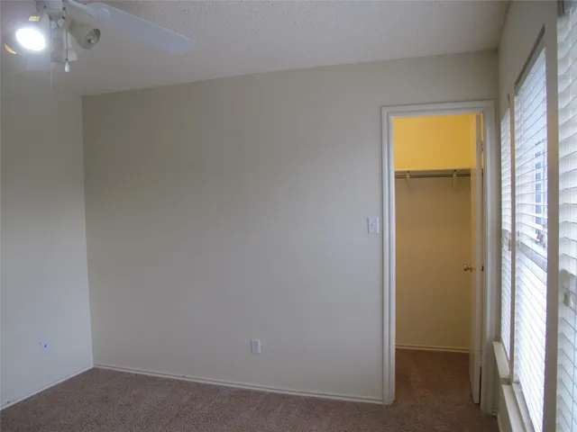 a view of a hallway with wooden shelves