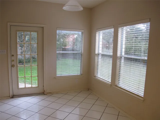 a view of an empty room with windows