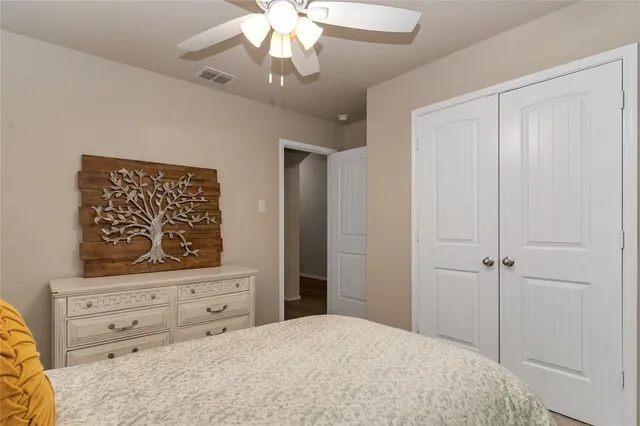 a bedroom with a bed and a dresser