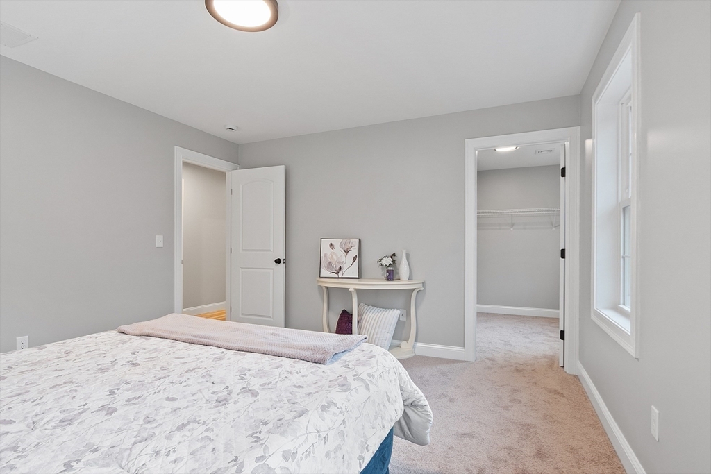 2 Davis Road Westminster, MA 01473 - Photo 29 of 41 a bedroom with a large bed a mirror and vanity
