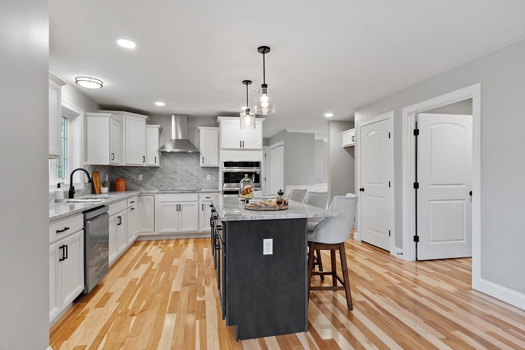 2 Davis Road Westminster, MA 01473 - Photo 4 of 41 a kitchen with stainless steel appliances granite countertop a sink stove and wooden floor