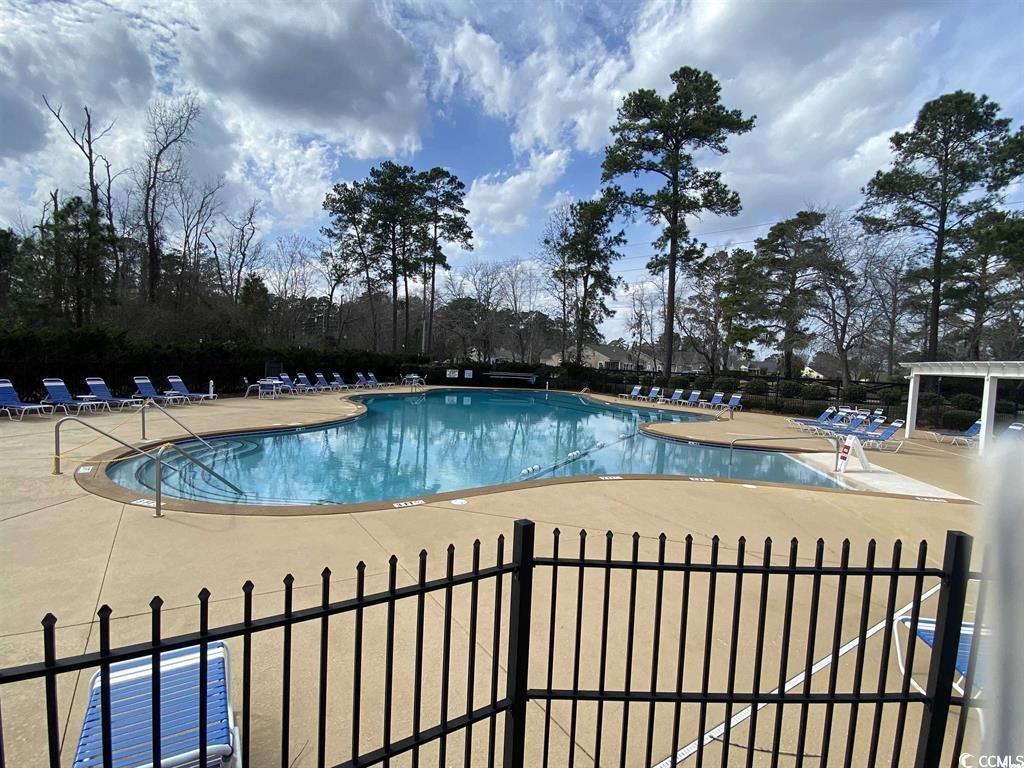 634 McCown Drive Conway, SC 29526 - Photo 5 of 7 Community pool with a patio area and view of scattered trees