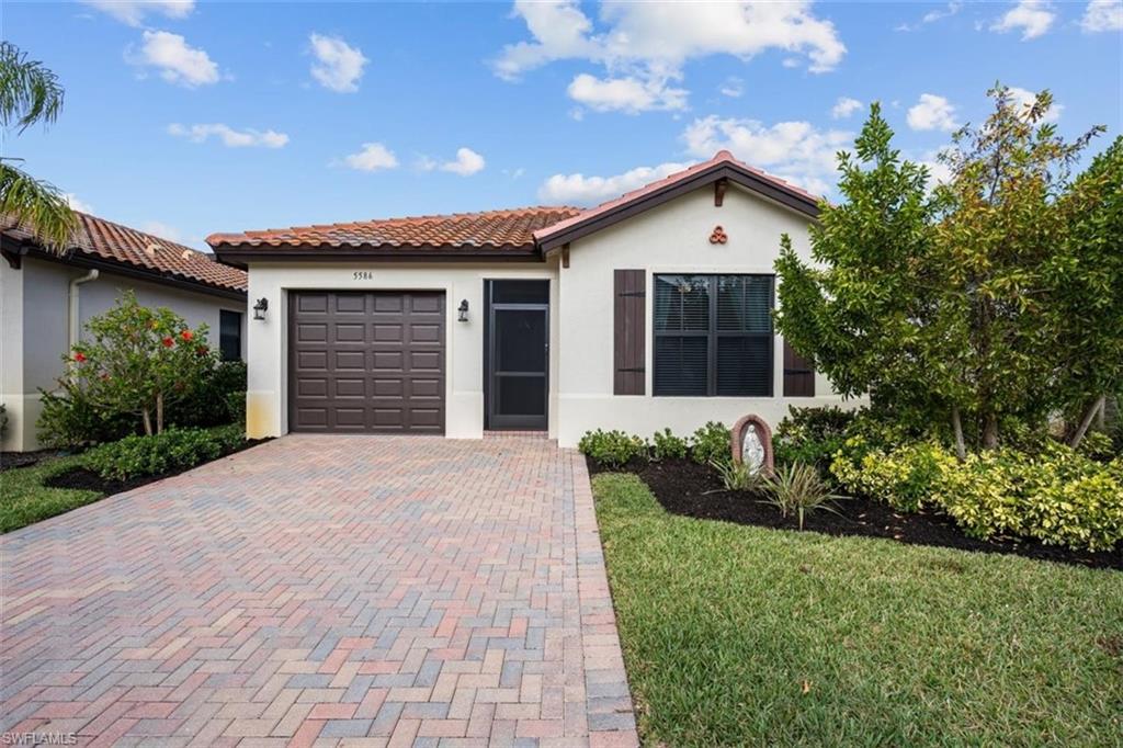 a front view of house with yard and green space