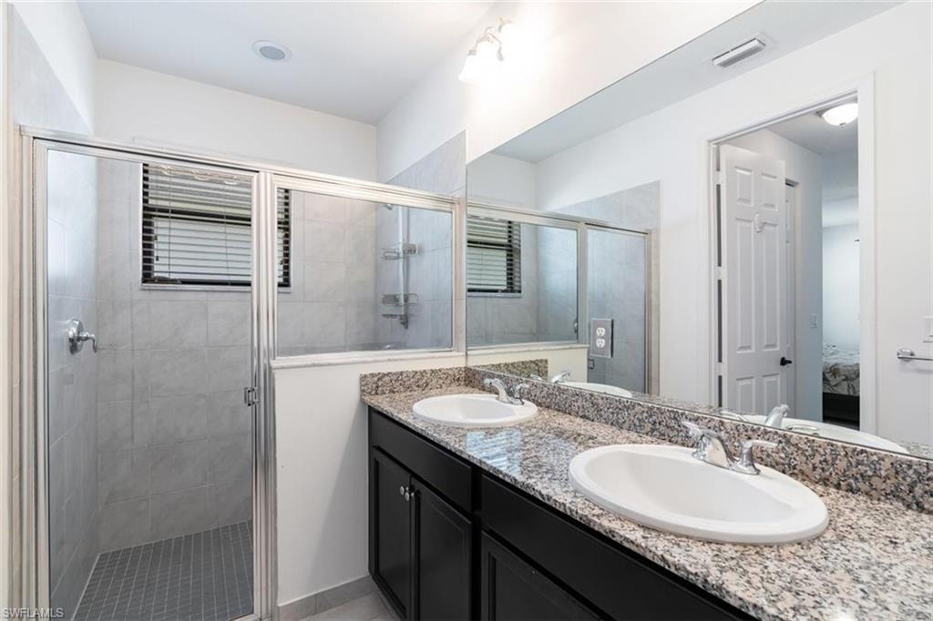 5586 Useppa Drive Ave Maria, FL 34142 - Photo 13 of 30 a bathroom with a granite countertop sink and a mirror