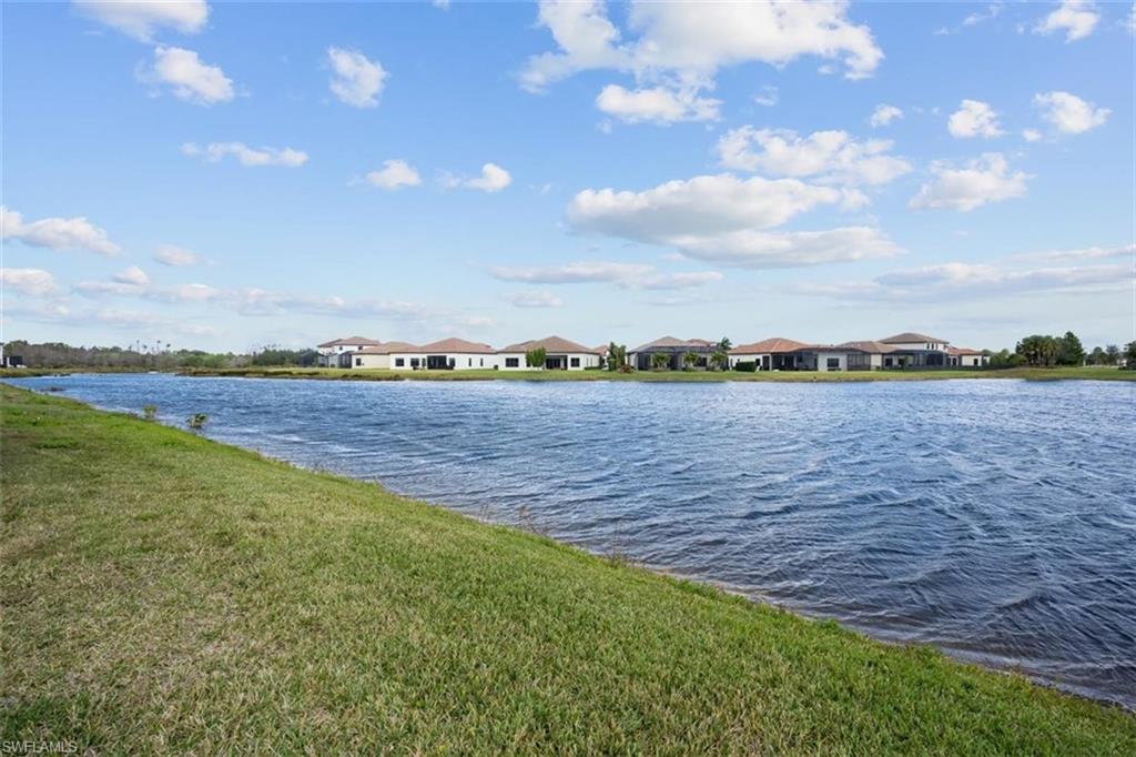 5586 Useppa Drive Ave Maria, FL 34142 - Photo 20 of 30 a view of a city with lawn chairs and wooden floor
