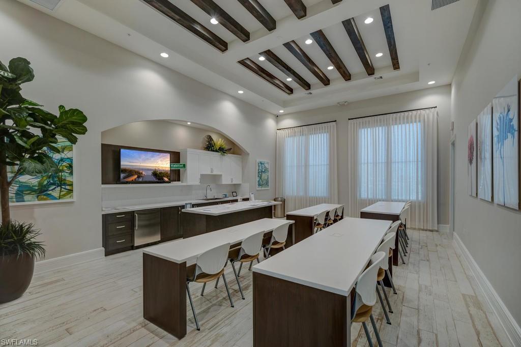 5586 Useppa Drive Ave Maria, FL 34142 - Photo 29 of 30 a large kitchen with stainless steel appliances a stove a sink dishwasher and a refrigerator with wooden floor