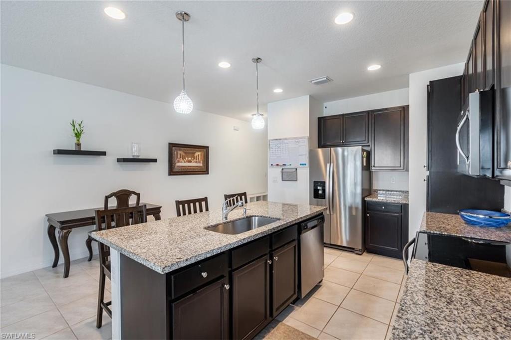 5586 Useppa Drive Ave Maria, FL 34142 - Photo 5 of 30 a kitchen with refrigerator and sink