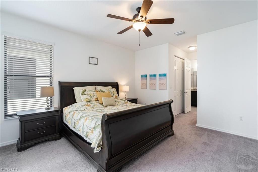 5586 Useppa Drive Ave Maria, FL 34142 - Photo 10 of 30 a bedroom with a bed and a ceiling fan