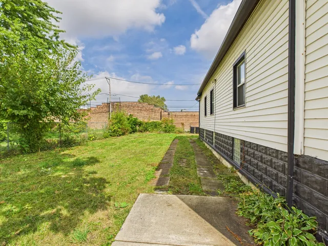 a view of backyard with swimming pool