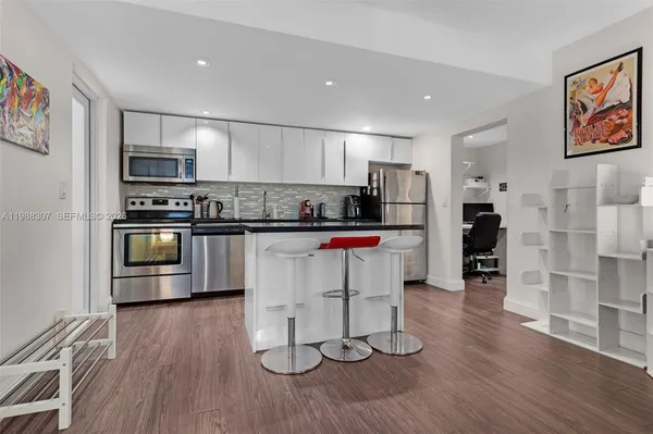 a bedroom with a bed and a painting on the wall