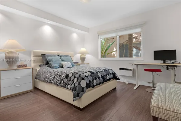 a bedroom with a bed and a desk
